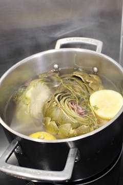 Cooked artichoke in a saucepan