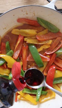 sliced peppers in a frying pan