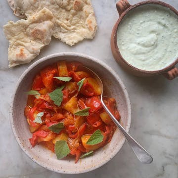 served stew with whipped feta and pitta bread