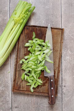 Chopped celery on a cutting board. 