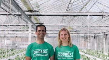 Oddbox founders standing next to each other wearing ODDBOX logo Tshirt