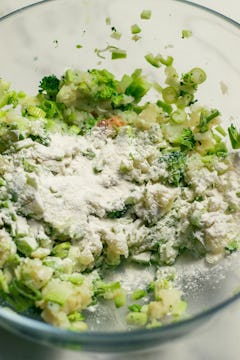 flour added to mashed potato and boiled broccoli in a bowl
