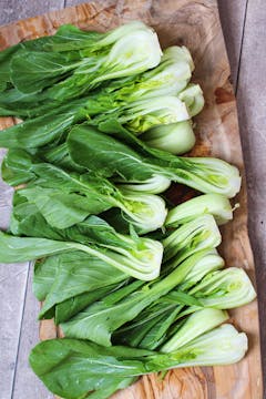 halved or quartered Pak Choi on a board