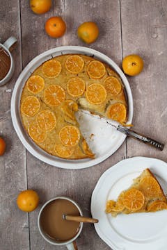 A candied Clementine cake. There's a slice taken out and put on a plate. 
