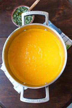 Blended carrot soup in a saucepan