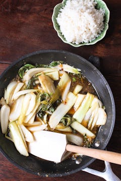 pan choi in frying pan and a bowl with cooked rice