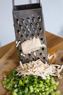tofu grated on chopping board