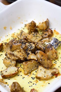 Jerusalem artichokes and miso butter in baking dish