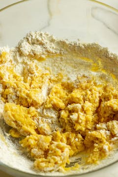 The empanada dough being assembled, barely mixed.