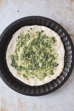 one pizza base on a baking tray