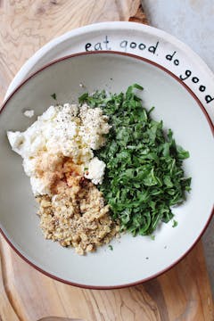 in a bowl, chopped rocket, crushed walnuts and ricotta 