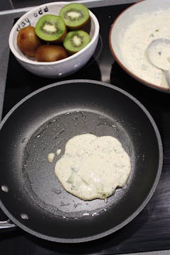 one pancake being cooked in a frying pan