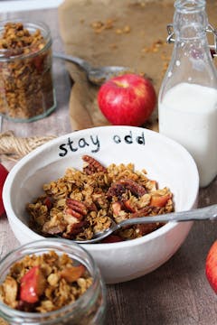 served apple granola on a bowl and on a jar for storing