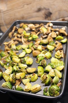 Cooked brussels and mushrooms in baking tray