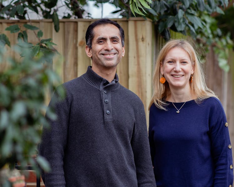 Oddbox founders Deepak Ravindran and Emilie Vanpoperinghe smile at the camera.