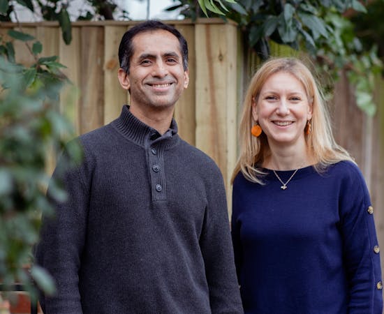 Oddbox founders Deepak Ravindran and Emilie Vanpoperinghe smile at the camera.