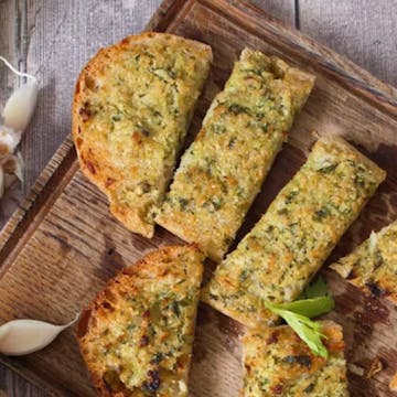 leftover cheesy bread on a chopping board