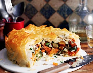 crispy brown half cut open vegetable pie