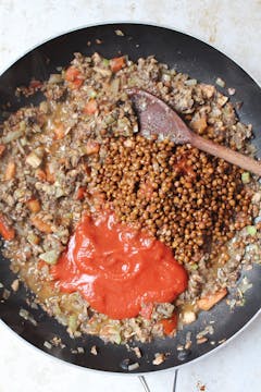 In pan, can of lentils, processed veg and tomato passata