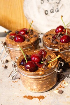 cherry and chocolate overnight oats topped with fresh cherries