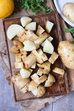chopped potatoes on board 