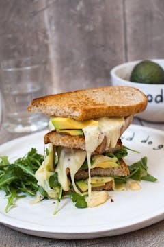 Plate with grilled cheese and avocado sandwich