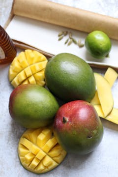 3 whole mangoes and 2 slice of mango on the skin cut into square shaped