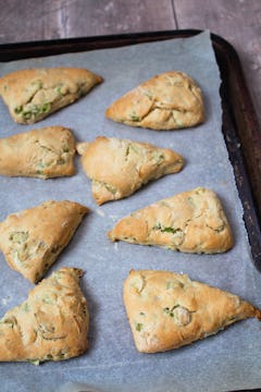 golden brown spring onion scones on a oven tray with baking sheet