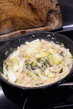 cooked rice and eggs in frying pan with pak choi