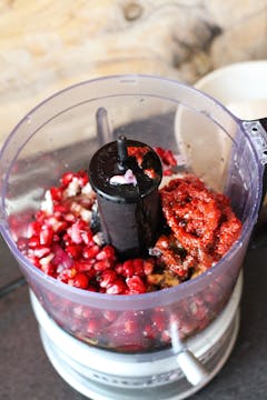 pomegranates being added to a blender