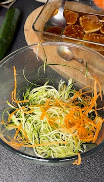 courgette and carrot ribbons in a clear bowl