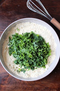 kale and dry ingredients in mixing bowl