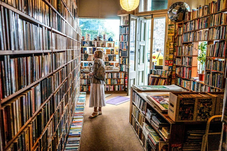 A customer in a bookshop browsing the shelves.