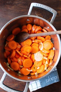 Chopped carrots and onions in a pan