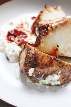 roasted celeriac drizzled with harissa paste and creme Fraiche