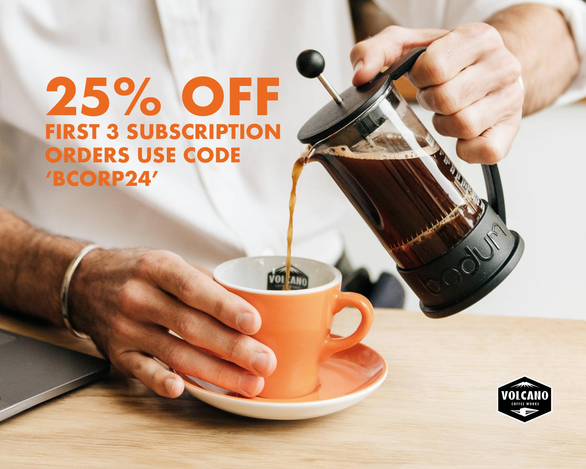 cafetière pouring coffee into an orange mug