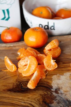 peeled clementines on a chopping board