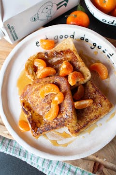 Clementine & Cinnamon Sugar French Toast on a white plate with Minor Figures oat milk in the background