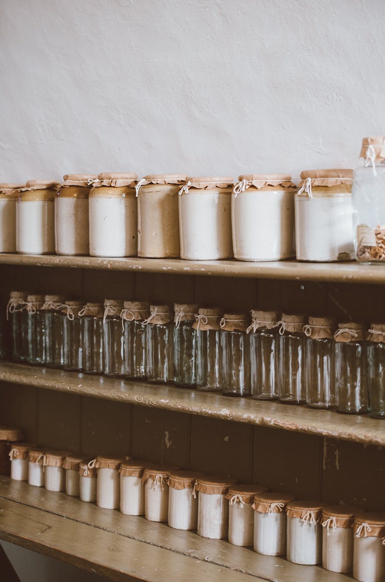 shelf with lots of containers aligned