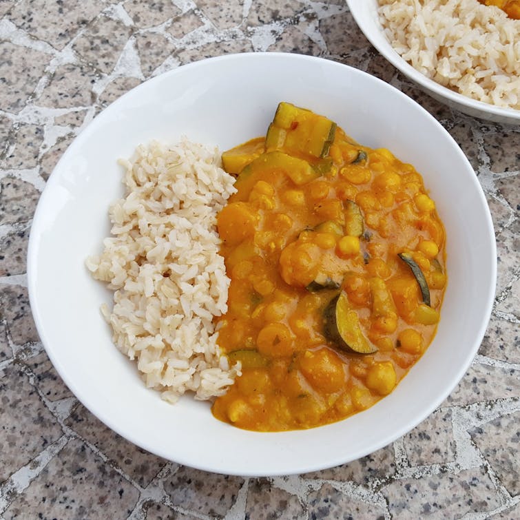 A plate of Mild Peanut and Coconut Milk Curry, served with rice.