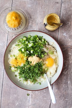wet and dry ingredients combined in a bowl to form potato cakes