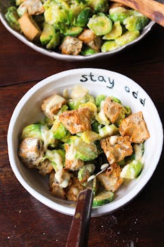 served up Brussels sprouts and caesar salad on a bowl