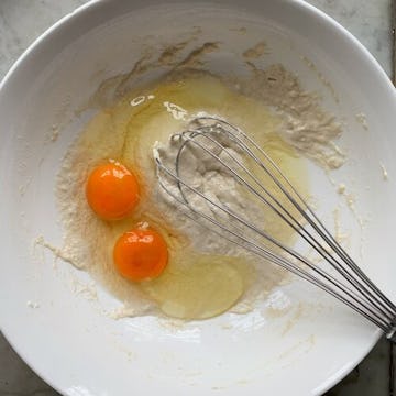 bowl of flour, water and 2 egg