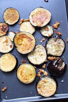 Cooked aubergine slices in baking tray