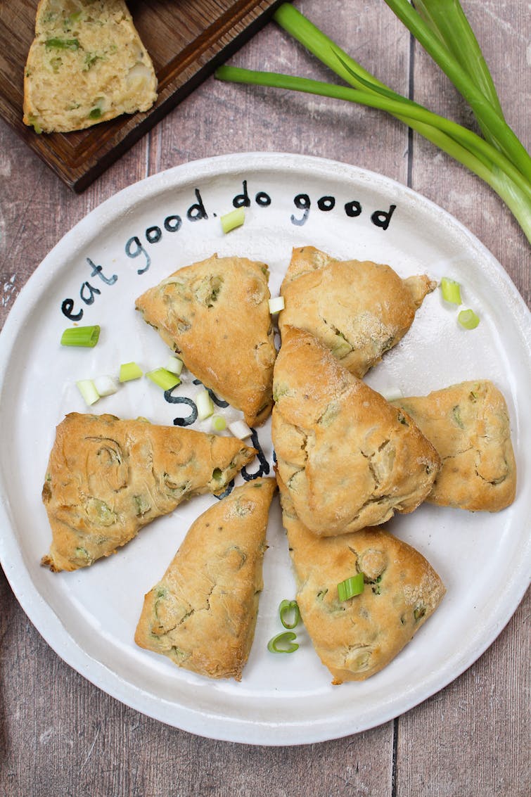 plate of 7 spring onion scones garnished with spring onion