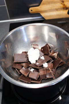 pieces of broken chocolate and coconut oil in a bowl