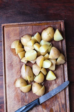 potatoes on chopping board 