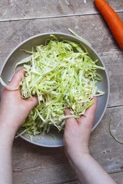 mixing cabbage with lime juice