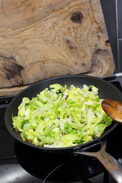 chopped lettuce in a frying pan