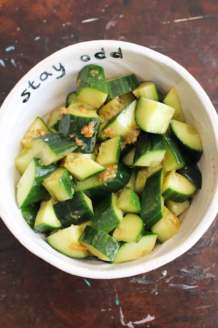 smacked cucumber salad served on a bowl